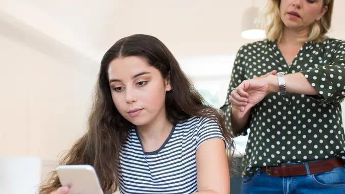 Mother Arguing With Teenage Daughter Over Use Of Mobile Phone.
