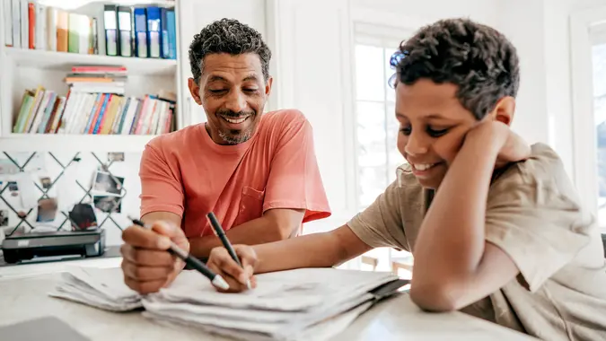Dad helping his son with his homework.