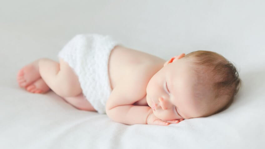 sleeping newborn baby on a blanket