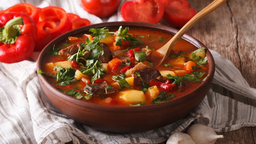 Homemade Hungarian Goulash soup bogracs close-up in a bowl on the table.