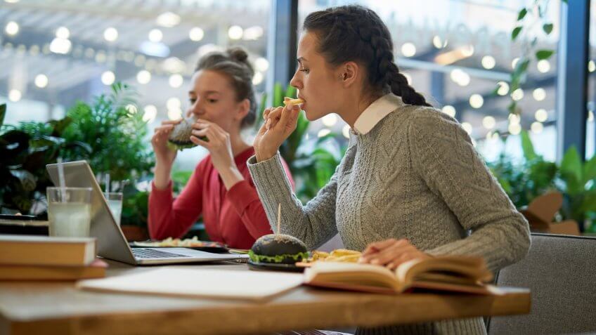 students eating food together in cafeteria