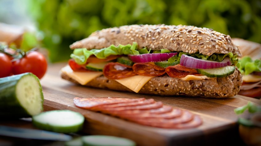 tasty sandwiches on a wooden table.
