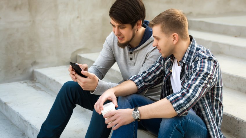 two guy friends talking about social media posts