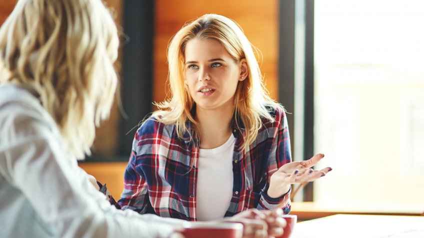two woman talking to one another about social media