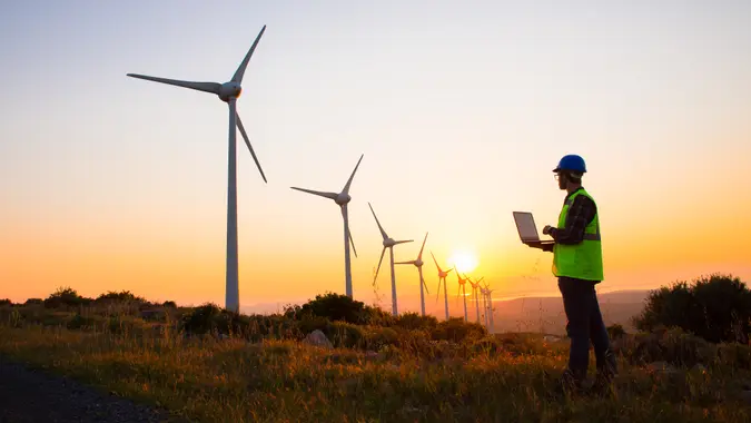 wind turbine technician at sunset