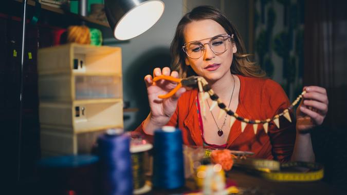 Woman making jewelry for hobbies at home.