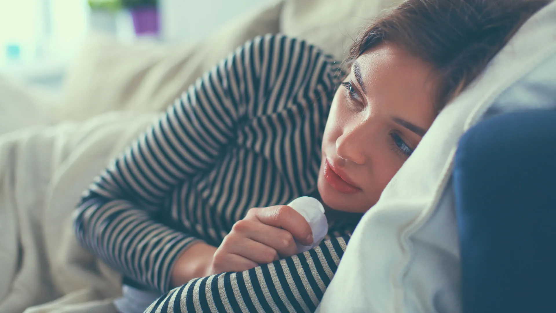 woman staying home sick from work