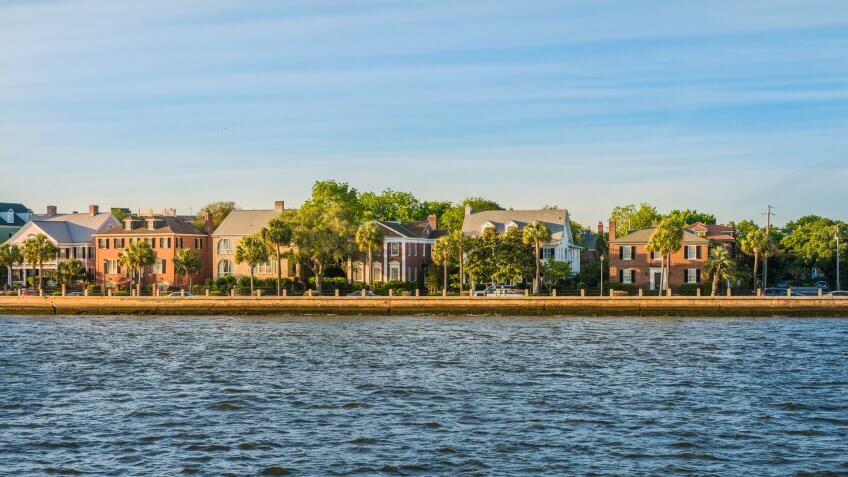 A view of waterfront homes in historic Charleston, South Carolina at sunset.