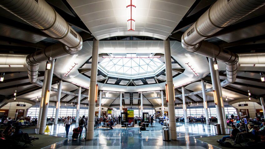 New Orleans, Louisiana, USA: June 10, 2016: Louis Armstrong International Departure Gate with Tourists.