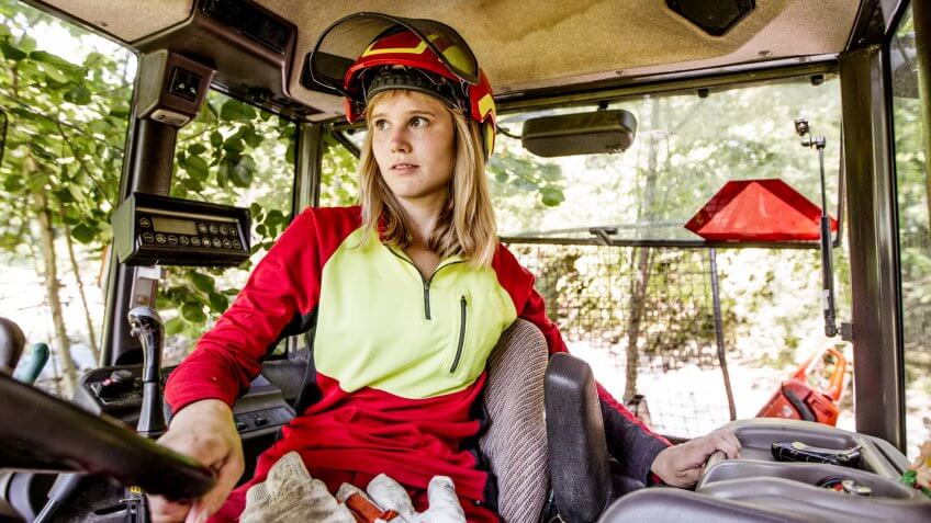 Young Lumberjack Woman Driving a Tractor.