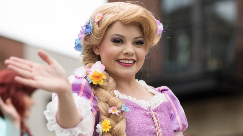 Holland, Michigan, USA - May 12, 2018 Members of Everafter West Michigan dress up as disney princess at the Muziek Parade, during the Tulip Time Festival.