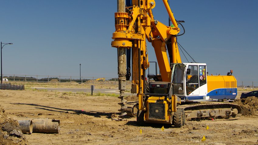 An industrial rotary drill used to create holes for footings and pilings.