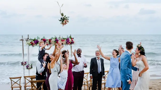 Bride throwing the bouquet at wedding.