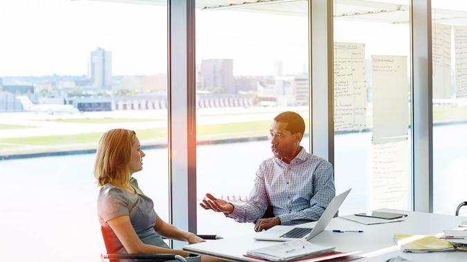 Shot of two colleagues having a meeting in an office.