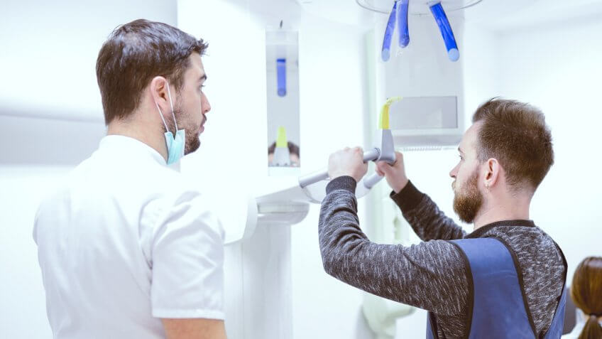 Handsome Male Preparing For Dental Cavity Scan.