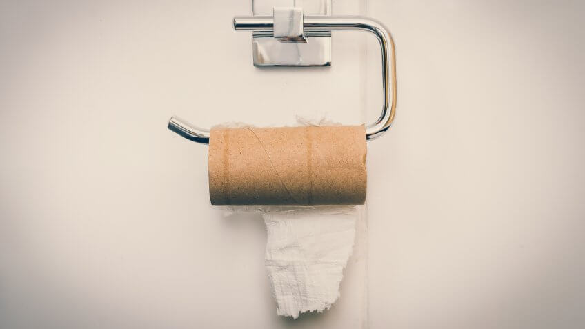 Empty toilet paper roll in public restroom.