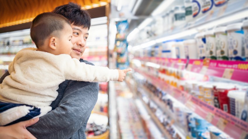 father and son shopping in a supermarket.