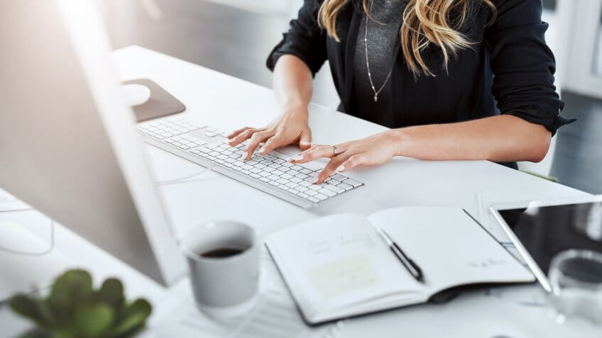Cropped shot of a businesswoman using a computer at her desk in a modern office.