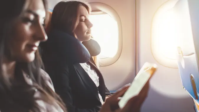 Two women going on a business trip by plane.