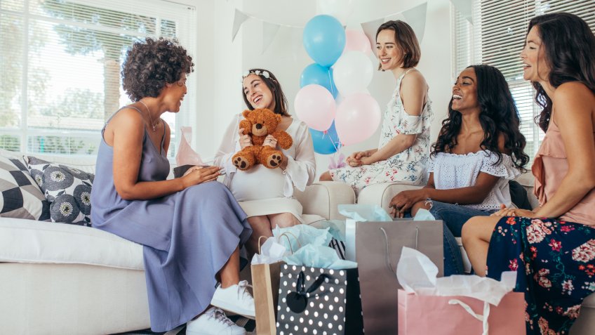 friends giving gifts at baby shower