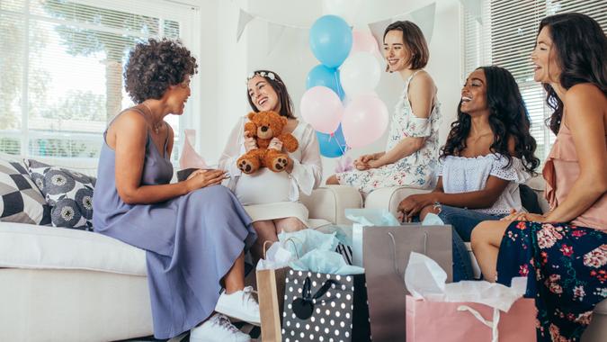 friends giving gifts at baby shower-shutterstock_796828333 friends giving gifts at baby shower