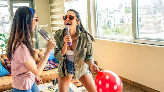 friends having fun singing in new house.