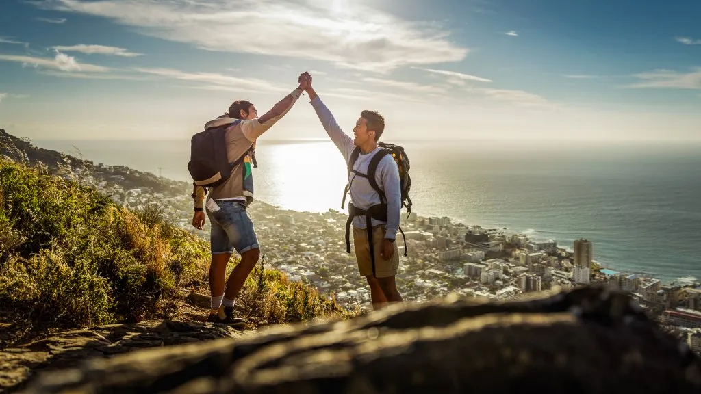 gay couple celebrating hiking success