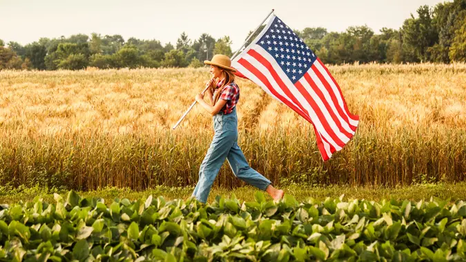 girl running through soybean farm field