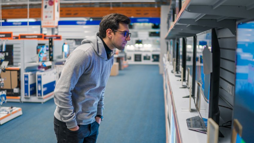 male consumer shopping for electronic television