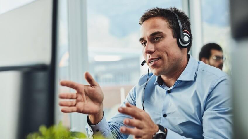 Shot of a young call centre agent working in an office.