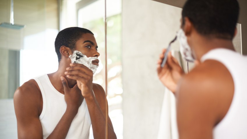 A young man shaving in the mirrorhttp://195.