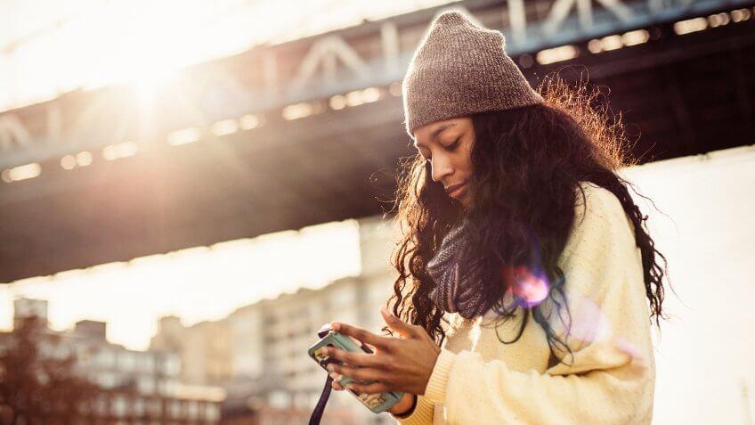 Hispanic woman using Smartphone in New York City.