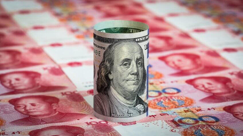 one hundred dollar bill with chinese yuan currency