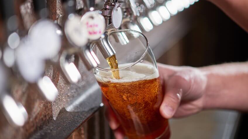 Craft beer being poured.