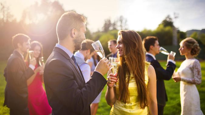 wedding guest couple drinking champagne