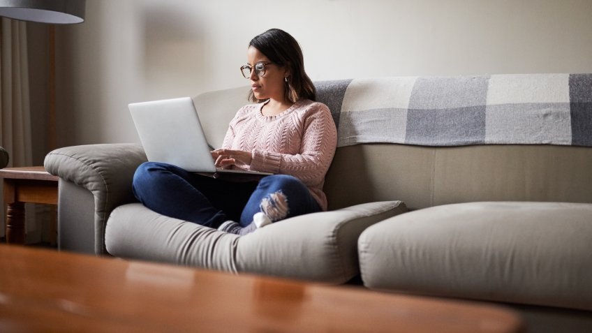 woman browsing Redfin real estate website at home