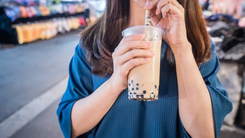 woman drinking boba dairy latte