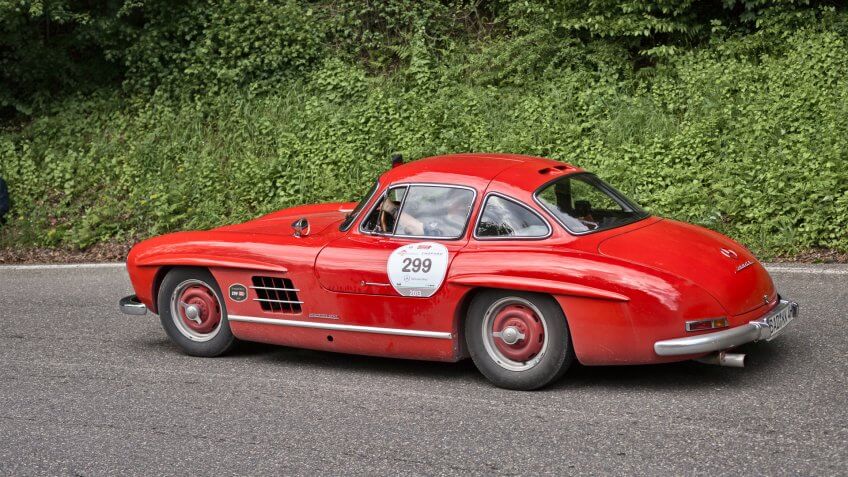 PASSO DELLA FUTA (FI), ITALY - MAY 18: driver and co-driver on old sports car Mercedes Benz 300 SL W 198 (1954) in historic Italian race Mille Miglia on May 18, 2013 in Passo della Futa (FI) Italy - Image.