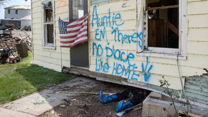 Mandatory Credit: Photo by Nati Harnik/AP/Shutterstock (6399042a)A stuffed pair of pants and blue boots are seen, under a house that was lifted off it's foundation by Saturday's tornado in Hallam, Neb.