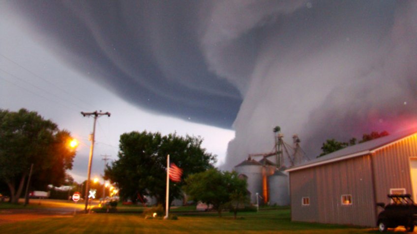 Mandatory Credit: Photo by Lori Mehmen/AP/Shutterstock (9614247a)A huge tornado funnel cloud touches down in Orchard, Iowa, at 9:04 p.