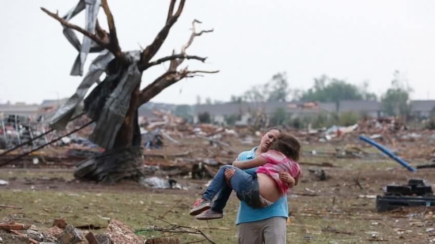 Mandatory Credit: Photo by Sue Ogrocki/AP/Shutterstock (6211799a)LaTisha Garcia carries her 8-year-old daughter, Jazmin Rodriguez near Plaza Towers Elementary School after a massive tornado carved its way through Moore, Okla.