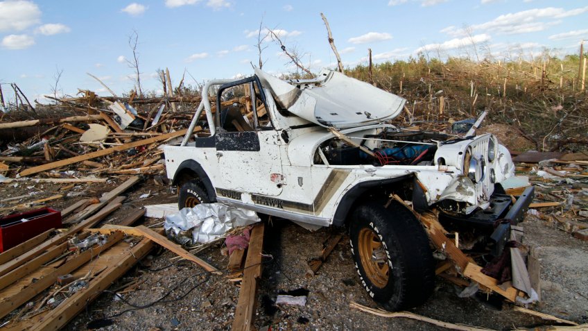 Mandatory Credit: Photo by Rogelio V Solis/AP/Shutterstock (6284601e)A Jeep shows the extent of Wednesday's tornado's force by its extensive damage in Phil Campbell, Ala.