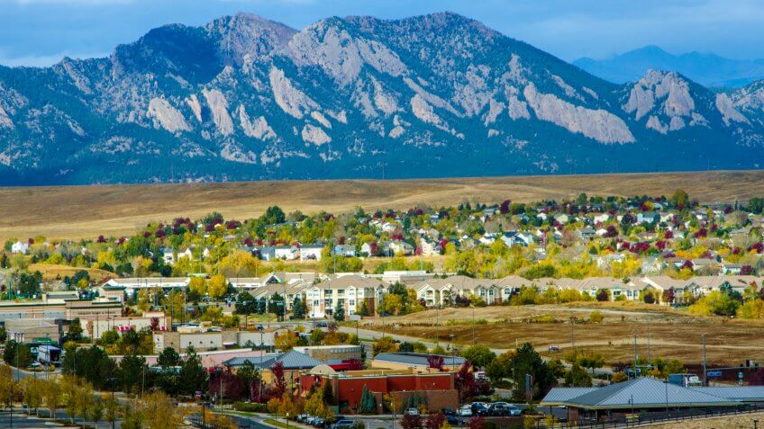 Broomfield, Colorado, USA - October 19, 2015: Urban sprawl from the developments in Broomfield, Colorado apprach the majestic range of the Flatiron Mountains.