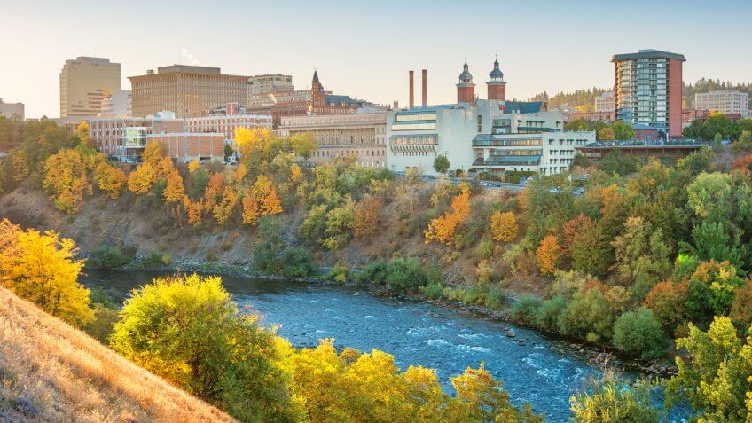 Stock photograph of the downtown Spokane, Washington skyline and the Spokane River at sunrise.