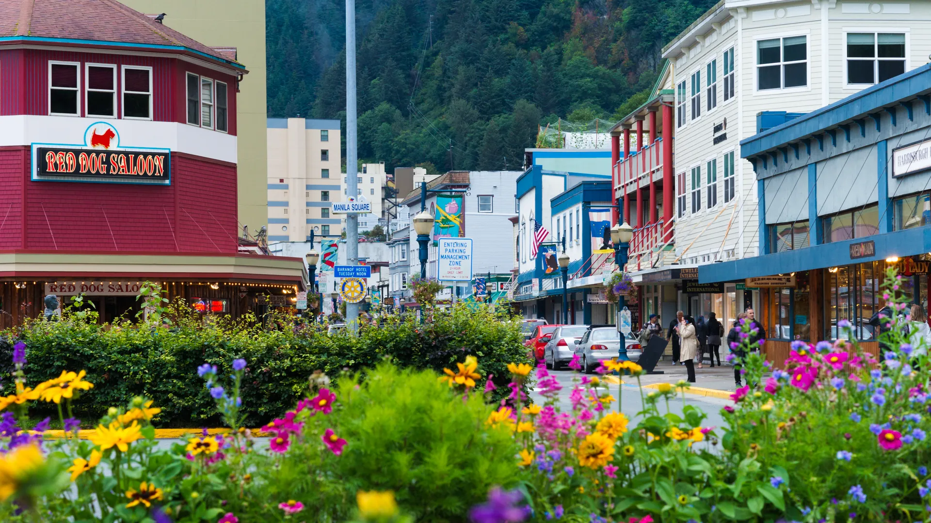 Alaska, USA - August 12, 2016: Downtown Juneau with flowers in the foreground with painted wooden storefront buildings and the Red Dog Saloon.