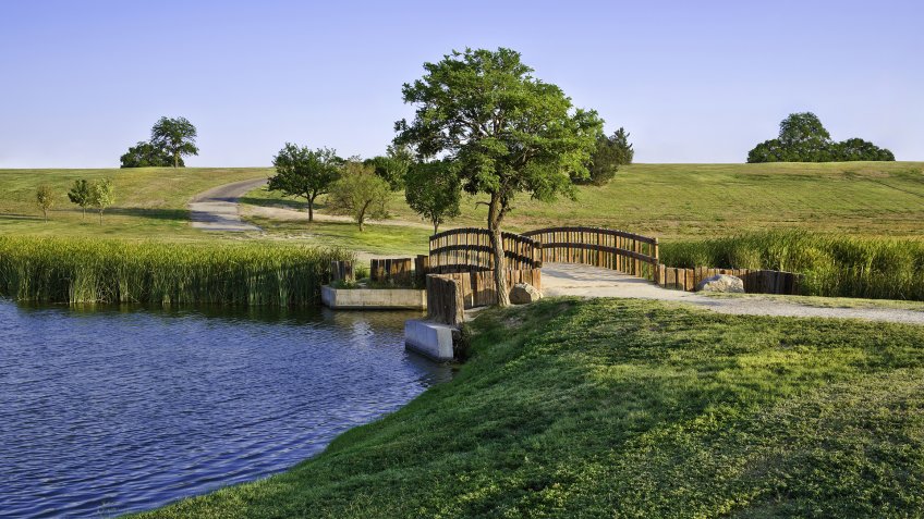 summer footbridge and lake In Lubbock Texas.