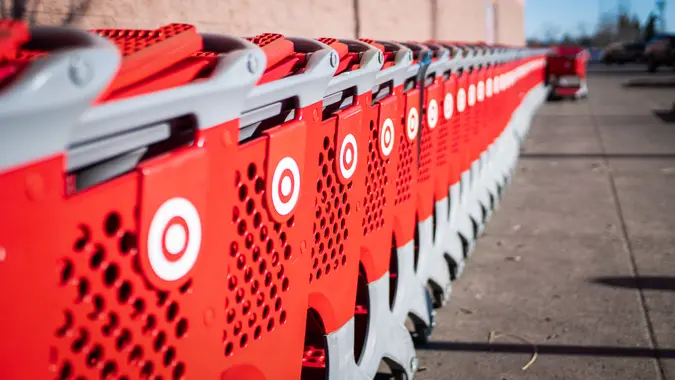 A line of Target store shopping carts outside of a Target store.
