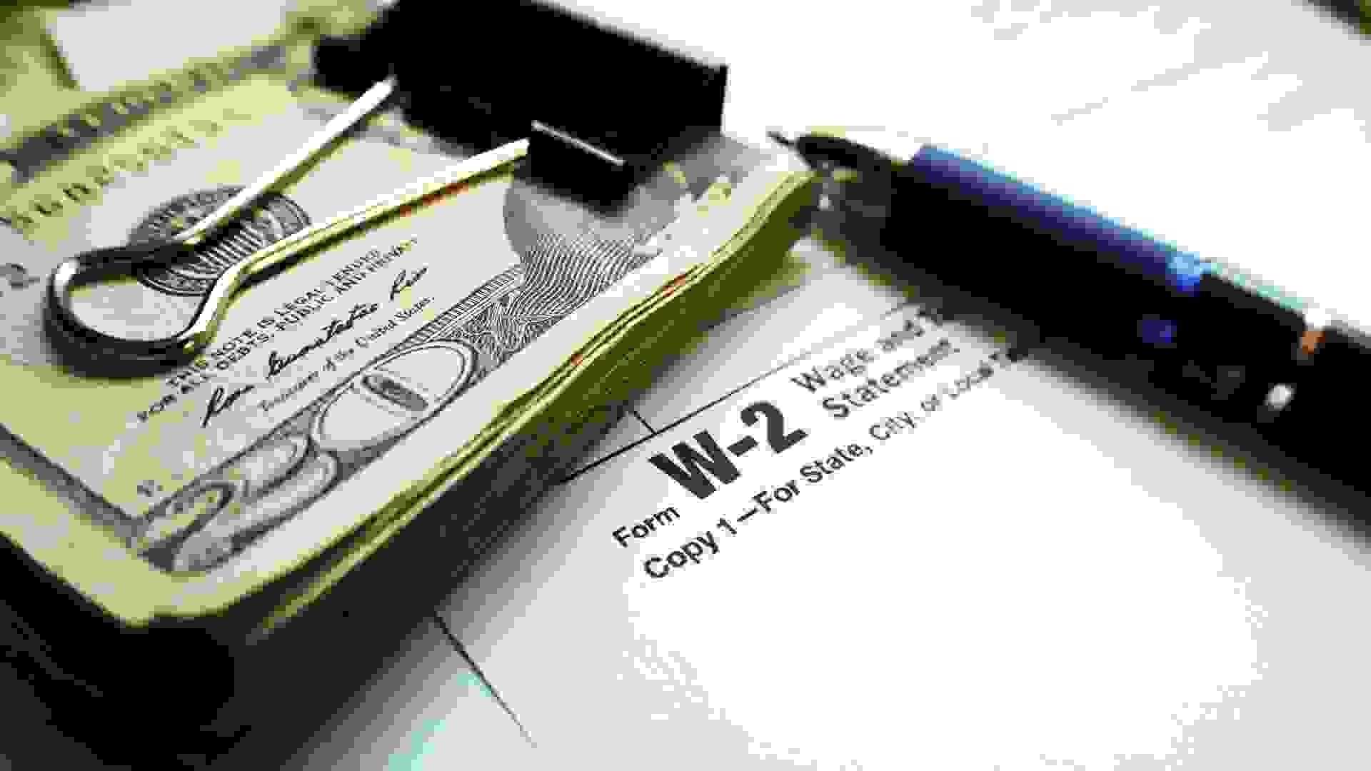 W-2 Tax form with Twenty Dollar Bills & Pen High Quality.