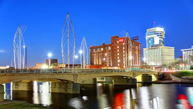 Wichita, Kansas, USA - April 27, 2018: Evening view of the Lewis Street Bridge bracketing downtown Wichita, crossing the Arkansas River.