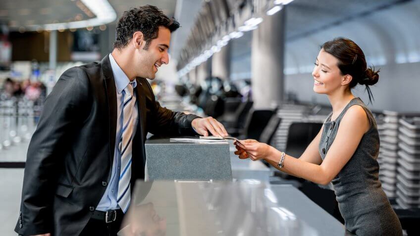 Business man traveling and doing check-in at the airport.